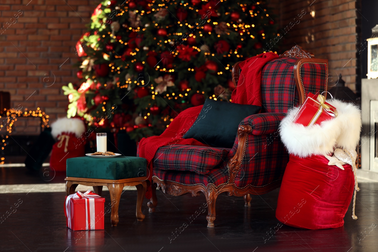 Photo of Santa Claus bag near armchair in room with Christmas tree