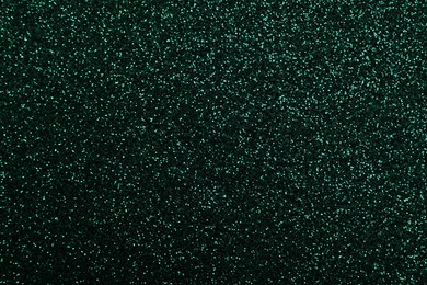 Photo of Shiny dark green glitter as background, closeup