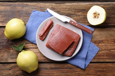 Photo of Flat lay composition with quince paste on wooden table