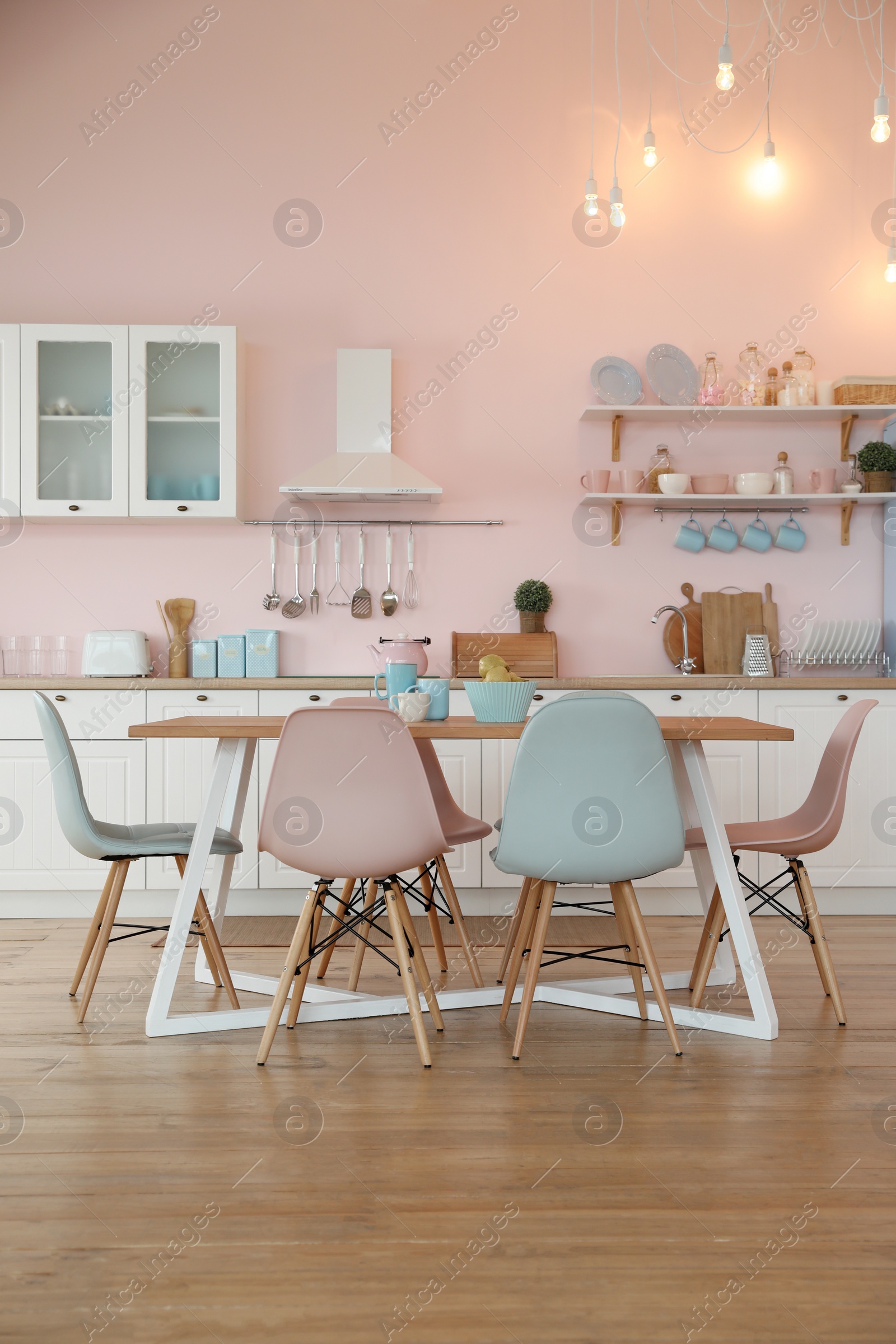 Photo of Stylish kitchen interior with dining table and chairs