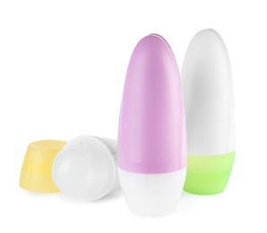 Photo of Different plastic deodorant containers on white background