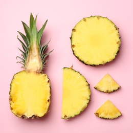 Photo of Flat lay composition with cut and fresh juicy pineapples on color background