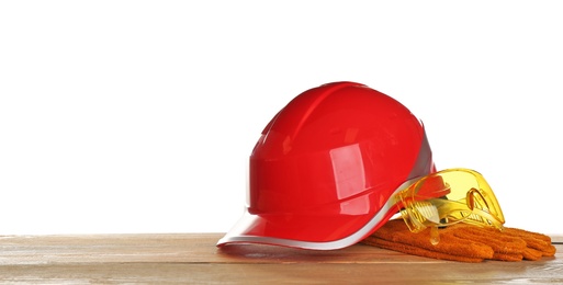 Photo of Set of safety equipment on table against white background