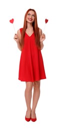 Photo of Young woman in red dress with paper hearts on white background
