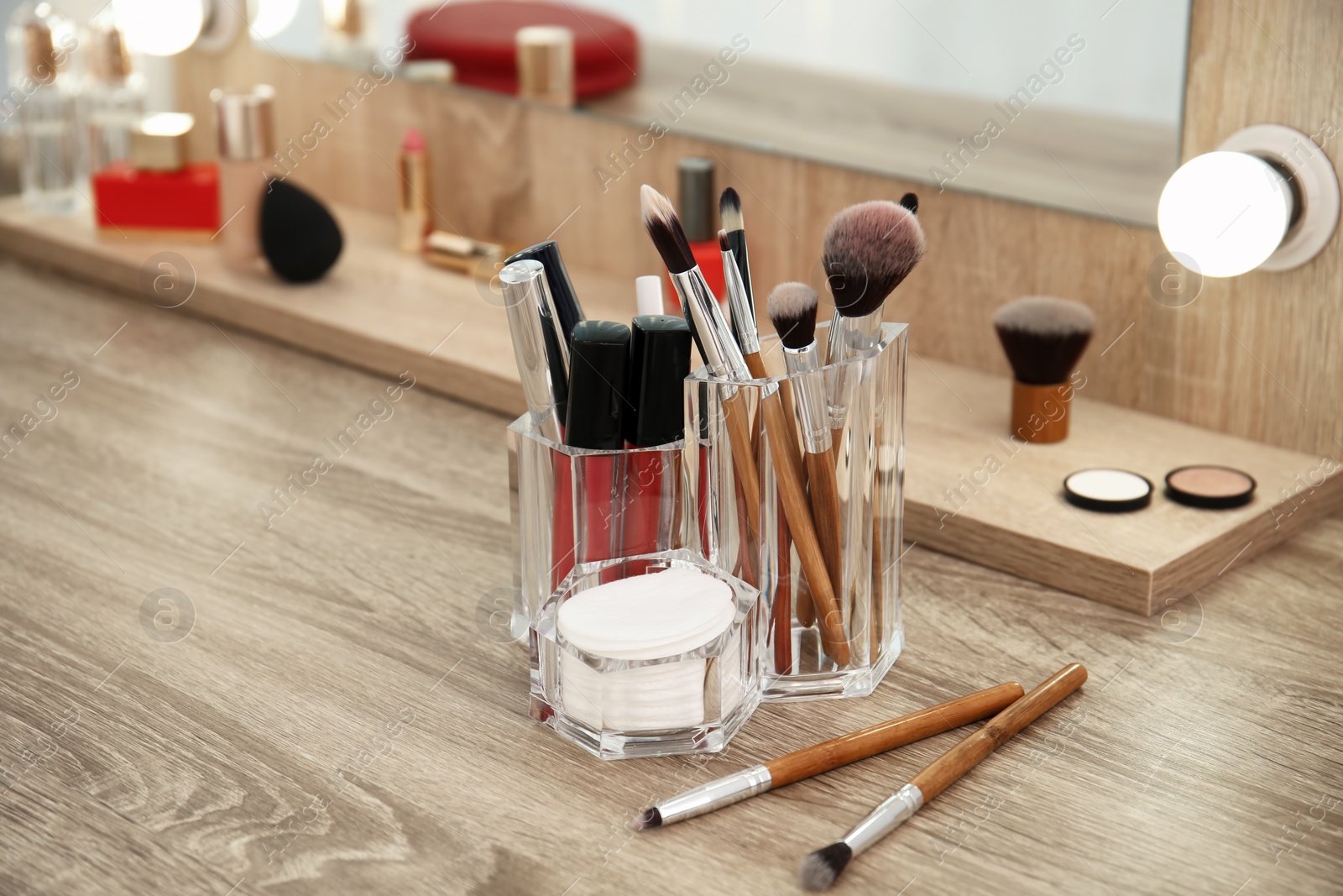 Makeup cosmetic products and tools on dressing table Photo of Makeup cosmetic products and tools on dressing table