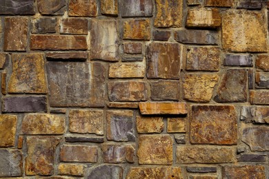 Photo of Beautiful stone wall as background, closeup view