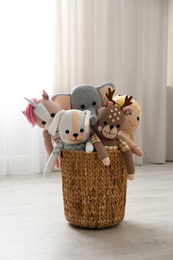 Photo of Funny toys in basket on floor. Decor for children's room interior