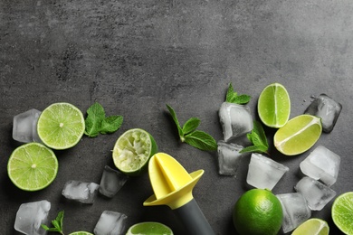 Photo of Flat lay composition with lime, mint and juicer on grey background. Refreshing beverage ingredients