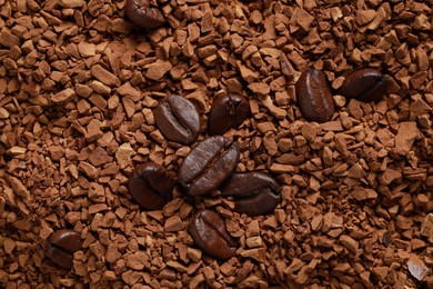 Photo of Roasted beans on instant coffee, flat lay