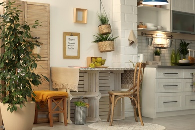 Photo of Modern kitchen interior with wooden crates as eco furniture