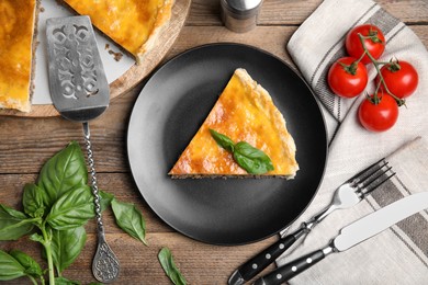 Photo of Piece of delicious pie with minced meat on wooden table, flat lay