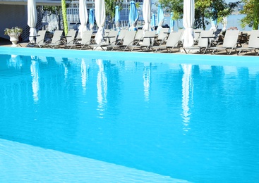 Photo of View of outdoor swimming pool with chaise longues
