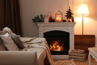 Photo of Fireplace in room with Christmas decorations. Interior design