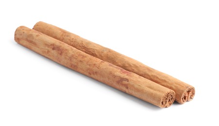 Photo of Dry aromatic cinnamon sticks isolated on white