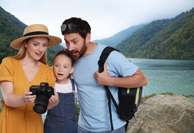 Image of Family with child in mountains. Mother showing fantastic photo on camera
