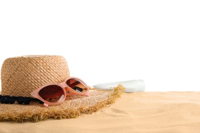 Photo of Composition with hat, beach sand and sunglasses on white background, space for text