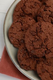 Photo of Delicious chocolate chip cookies on white table, top view