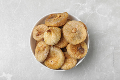 Photo of Tasty dried figs on light grey table, top view