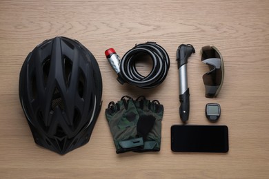 Photo of Flat lay composition with different cycling accessories on wooden background