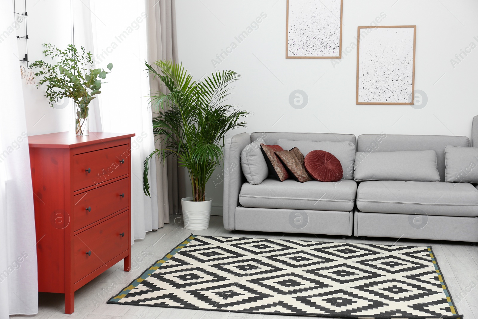 Living room interior with red wooden chest of drawers Photo of Living room interior with red wooden chest of drawers