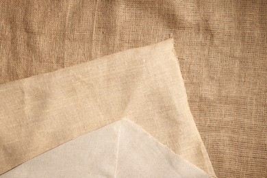 Texture of natural burlap fabric as background, top view