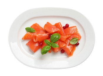 Photo of Salmon carpaccio with cranberries and basil isolated on white, top view