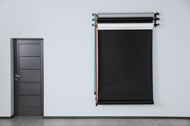 Photo of Colorful photo background rolls near door in office. Interior design