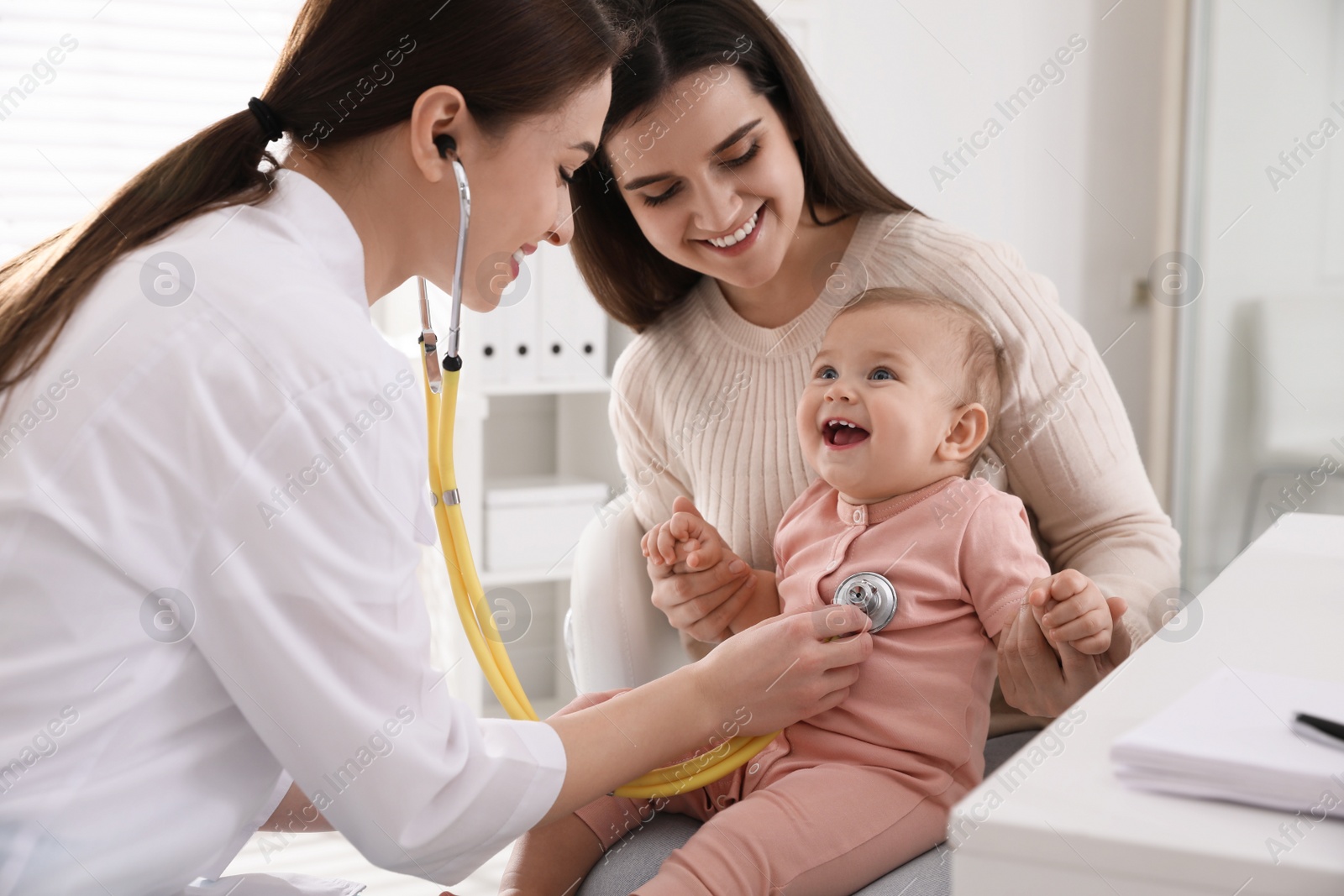 Photo of Mother with her cute baby visiting pediatrician in clinic