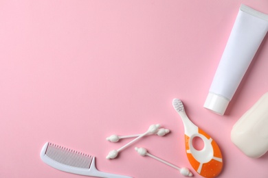 Photo of Flat lay composition with baby toothbrush, toiletries and space for text on color background