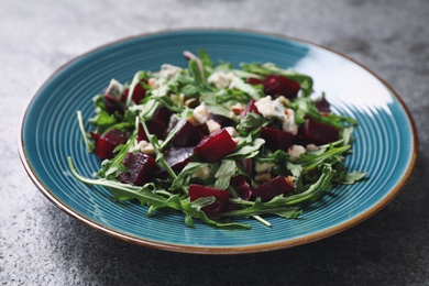 Photo of Fresh delicious beet salad on grey table, closeup