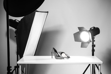 Photo of Professional photography equipment prepared for shooting stylish shoes in studio
