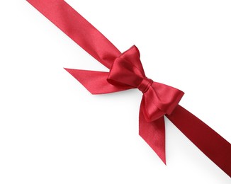 Photo of Red satin ribbon with bow on white background, top view