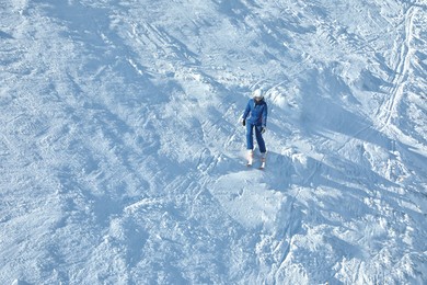 Photo of Female skier on slope at resort. Winter vacation