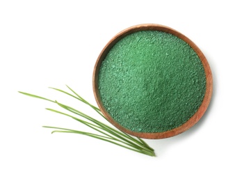 Photo of Bowl of spirulina algae powder and grass isolated on white, top view