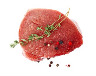 Photo of Fresh raw beef cut with thyme and peppers mix isolated on white, top view