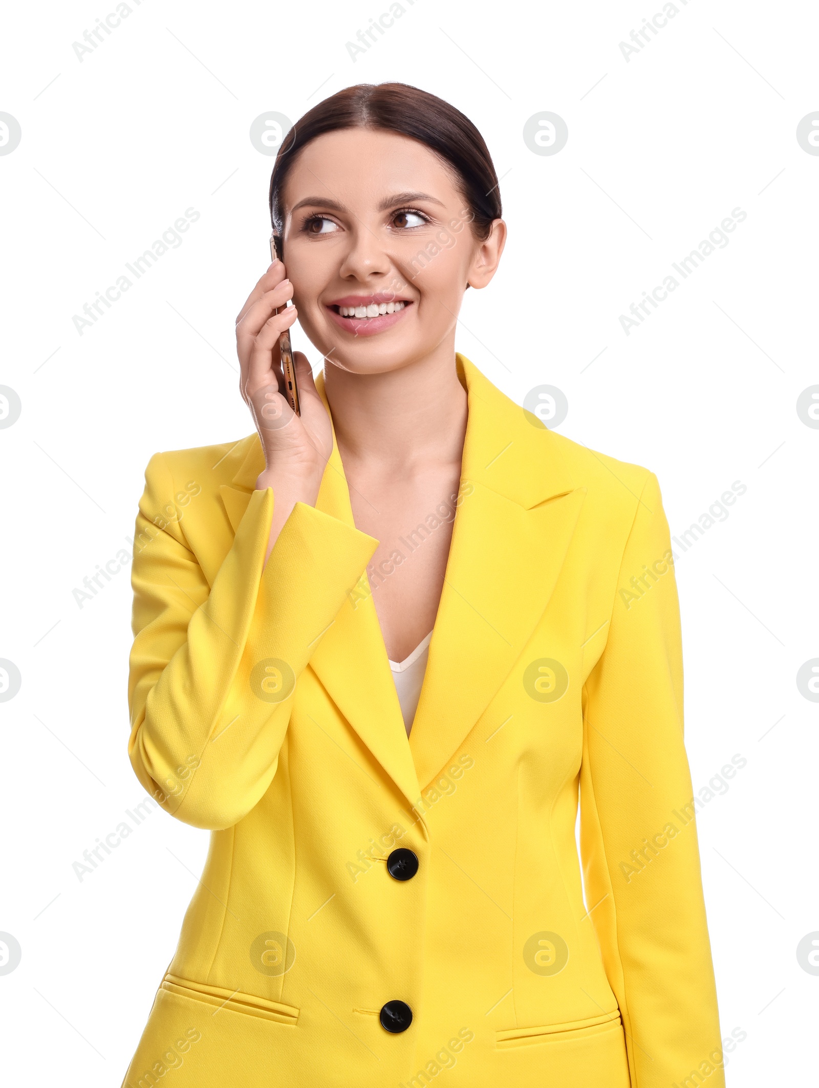 Photo of Beautiful businesswoman in yellow suit talking on smartphone against white background