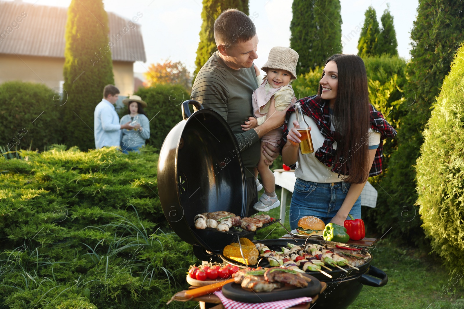 Photo of Family with friends having barbecue party outdoors