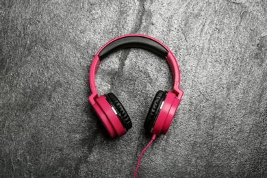 Stylish headphones on grey background, top view