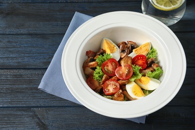 Photo of Plate with delicious fresh salad on table