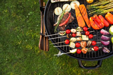 Delicious grilled vegetables on barbecue grill outdoors, top view. Space for text
