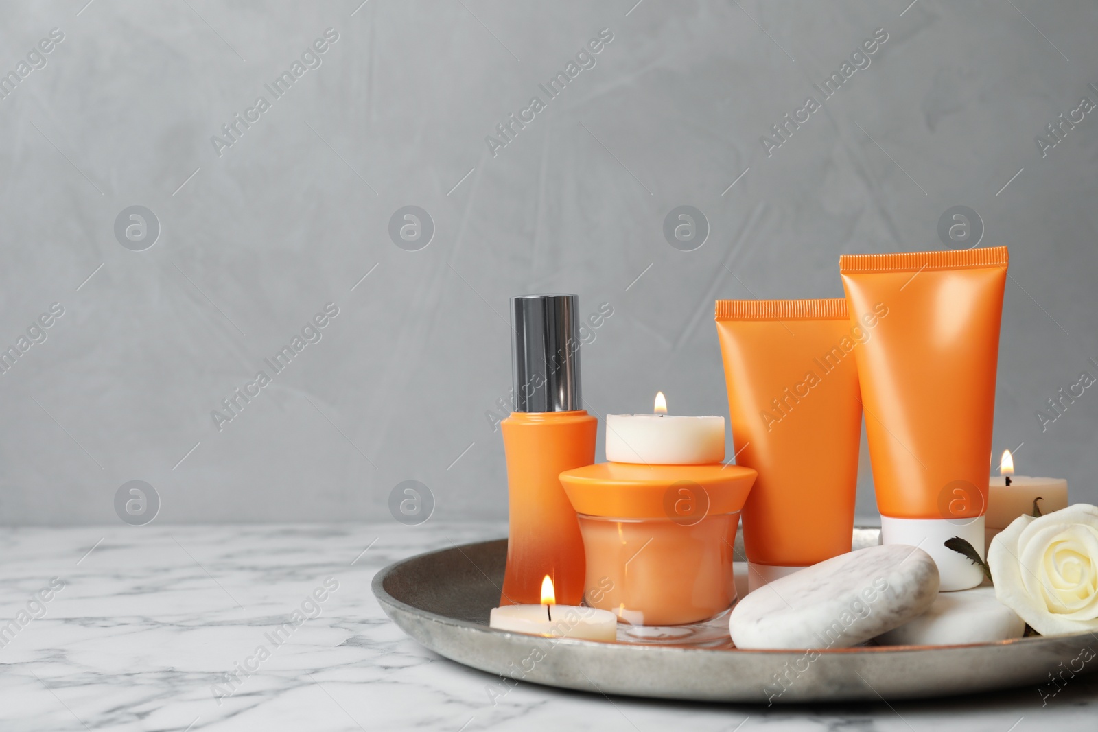 Photo of Composition with cosmetic products on white marble table. Space for text