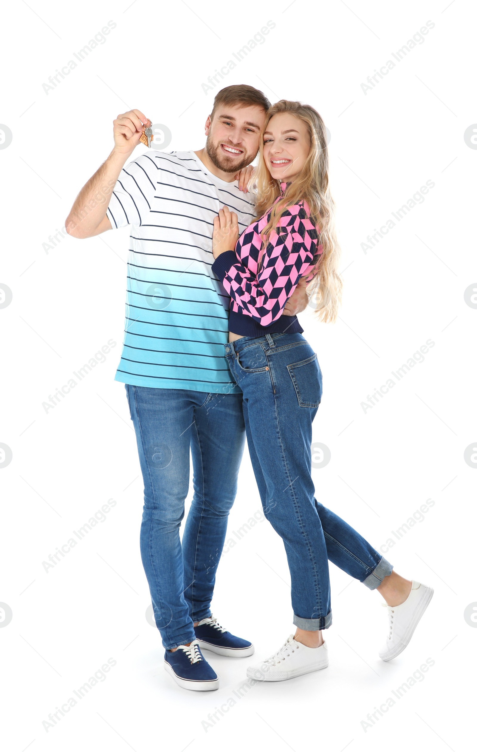 Photo of Happy young couple with house key on white background