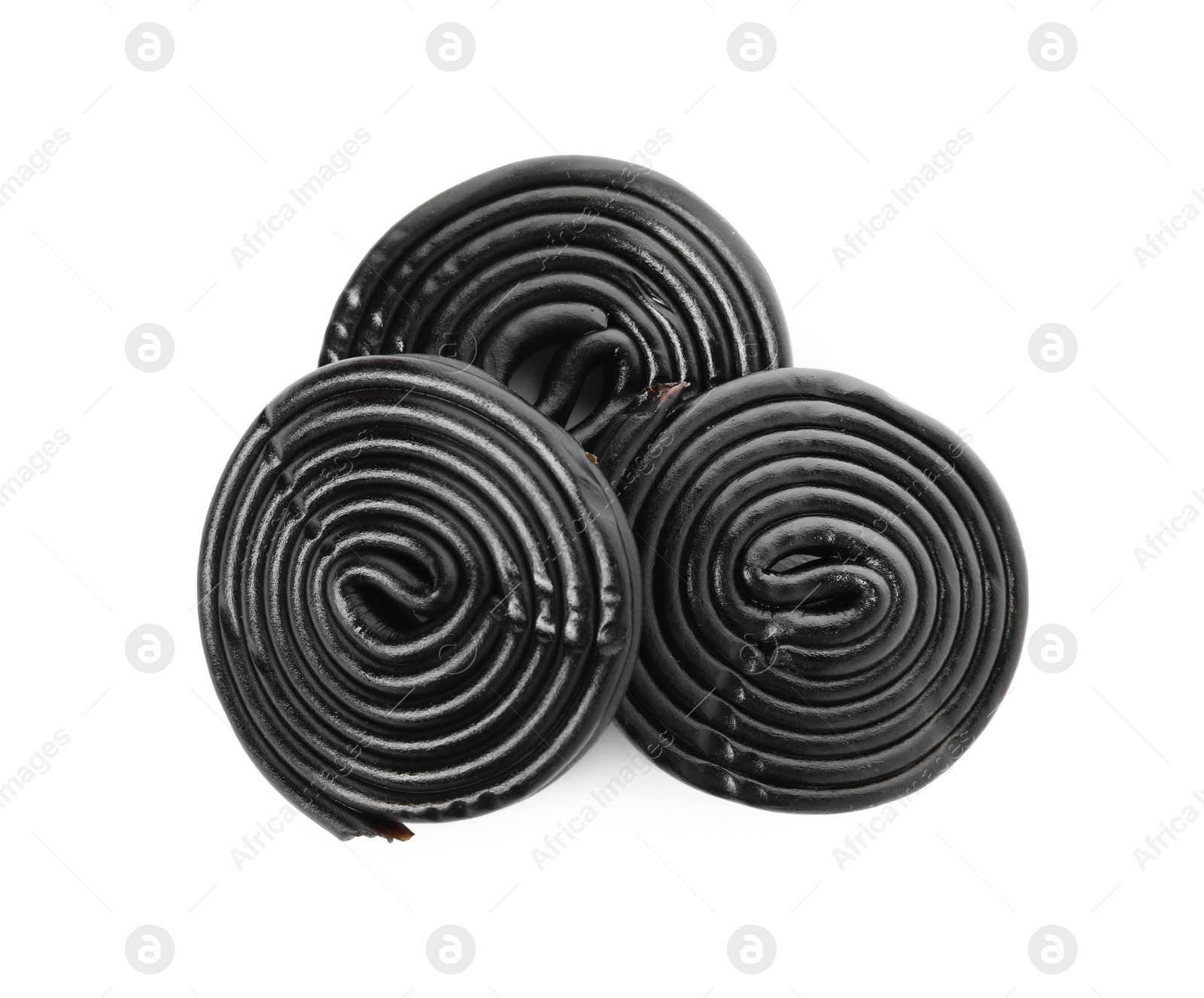 Photo of Tasty rolled liquorice candies on white background, top view