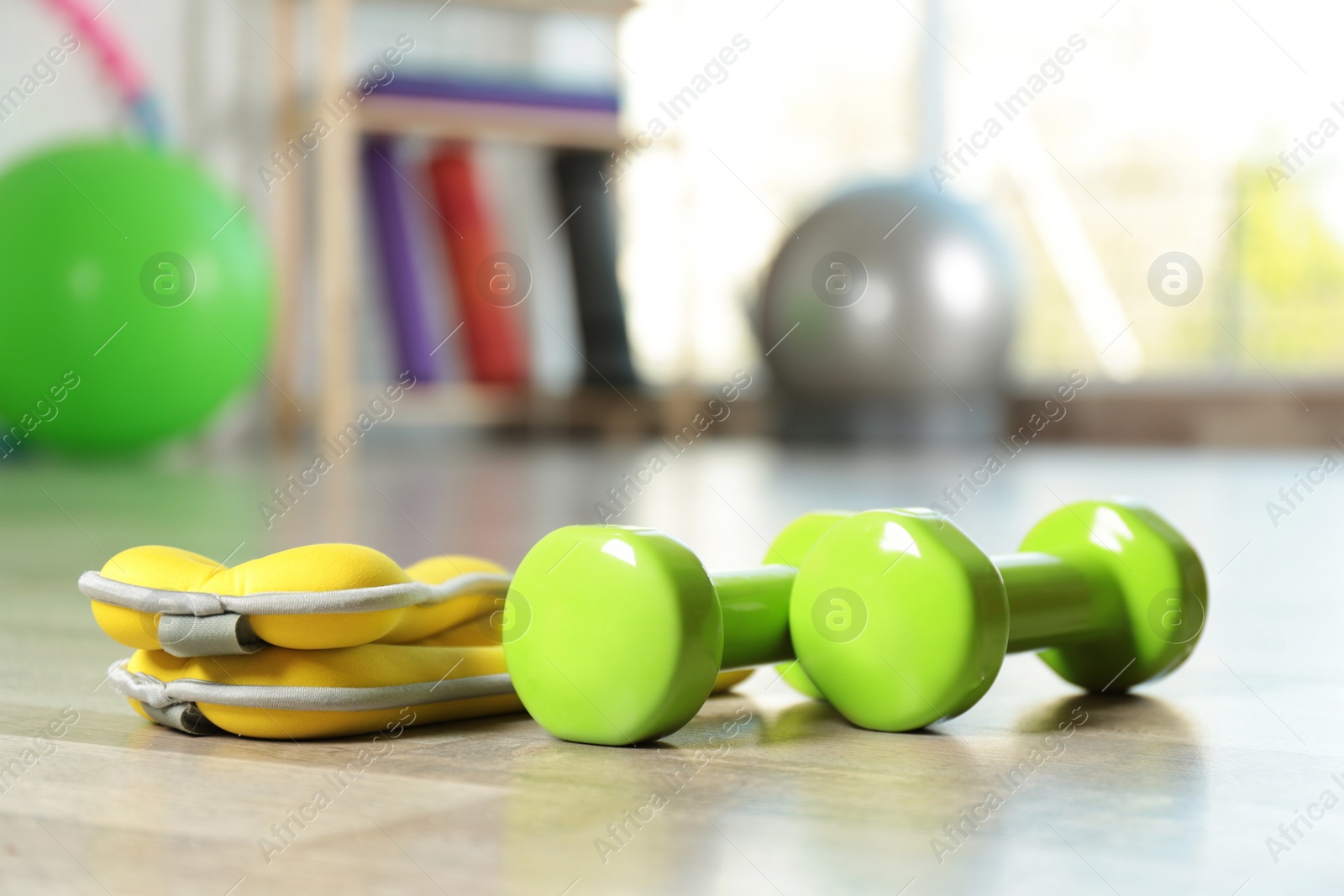 Photo of Fitness inventory on floor in spacious gym, space for text. Rehabilitation medicine