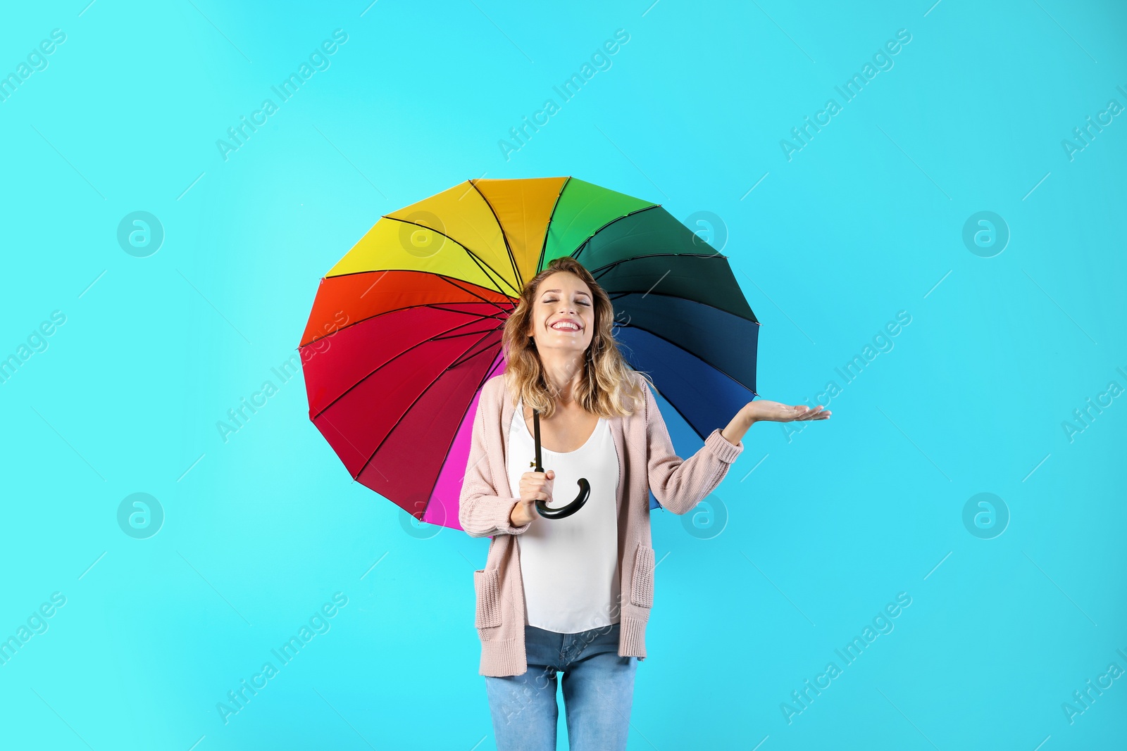 Photo of Woman with rainbow umbrella on color background