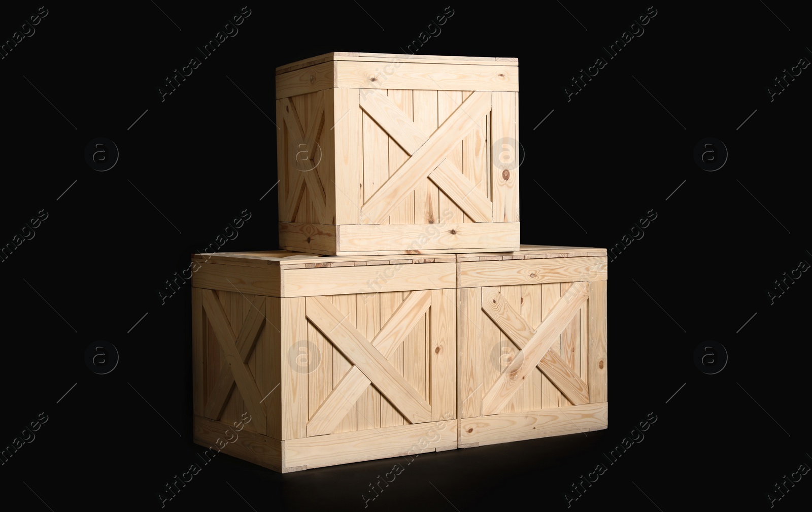 Photo of Group of wooden crates on black background