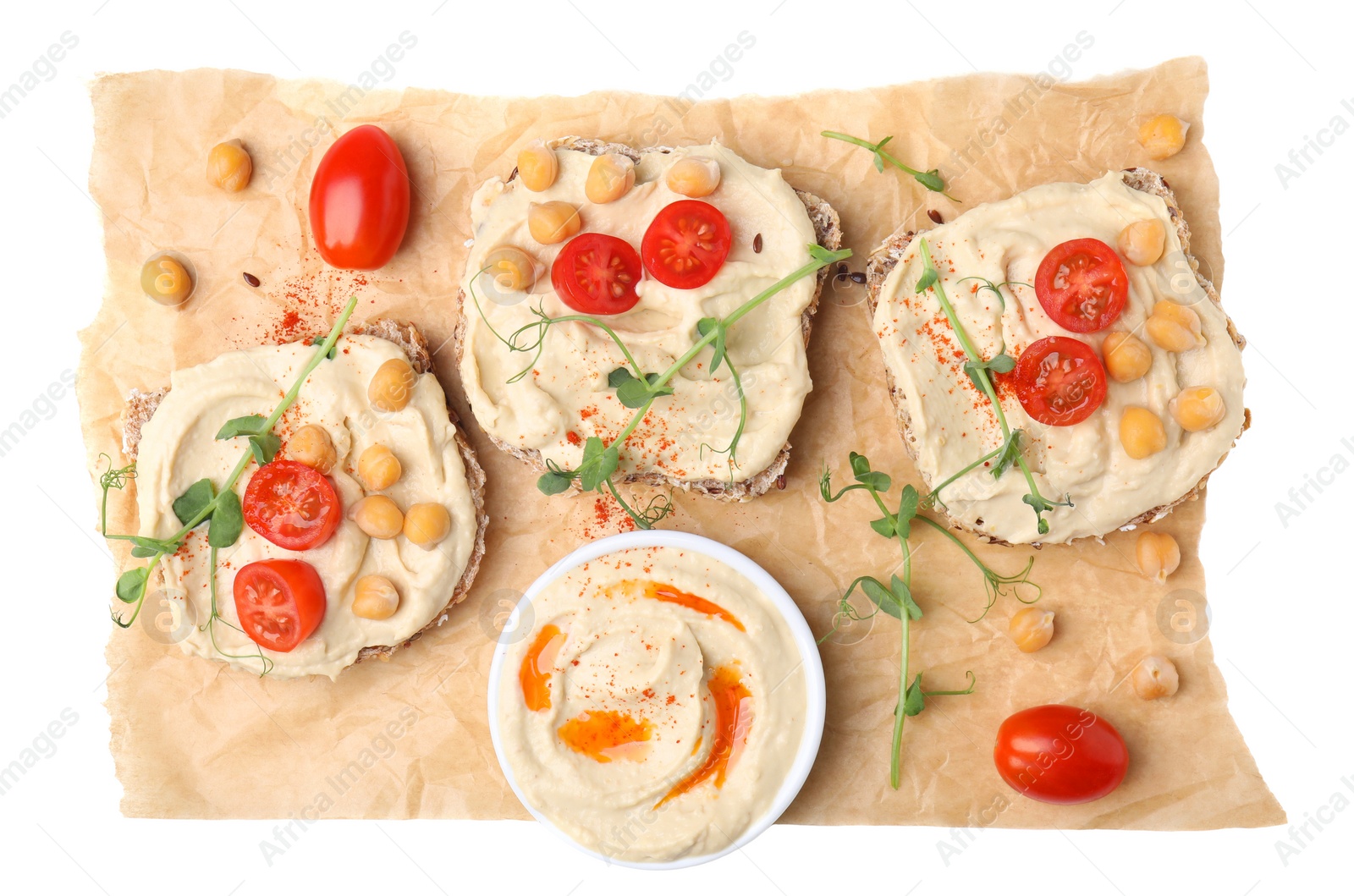 Photo of Delicious sandwiches with hummus and ingredients on white background, top view