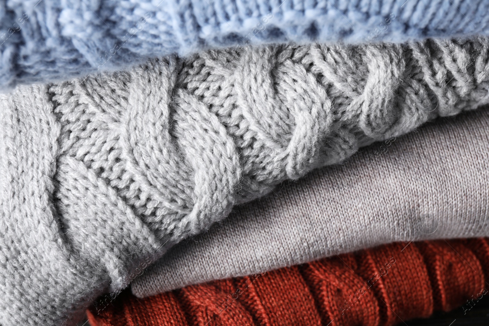 Image of Stack of folded warm sweaters, closeup view