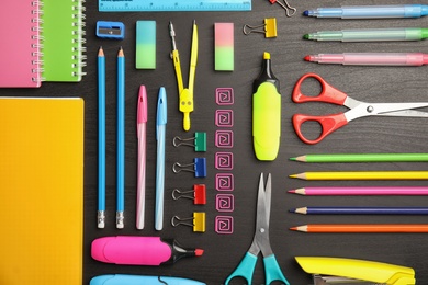 Photo of Different school stationery on wooden background, flat lay