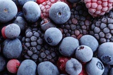 Photo of Mix of different frozen berries as background, top view